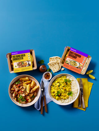 Two bowls of ready made meals with packages on a blue background