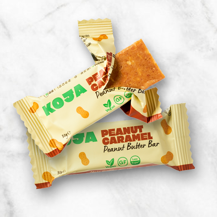 A low FODMAP snack bar, KOJA Peanut Caramel Peanut Butter Bar.