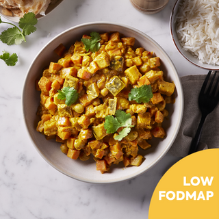 A photograph of a bowl filled with Southern Indian Vegetable Curry. This flavorful and aromatic low FODMAP meal is a delicious option.